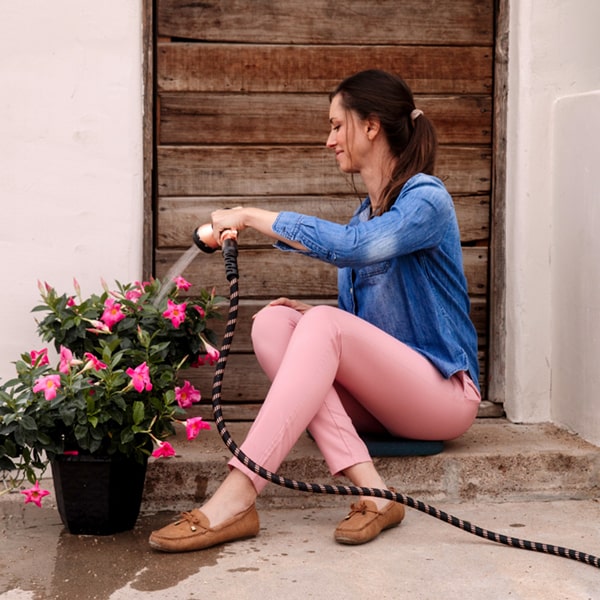 Copper Bullet in use by woman watering potted flowers